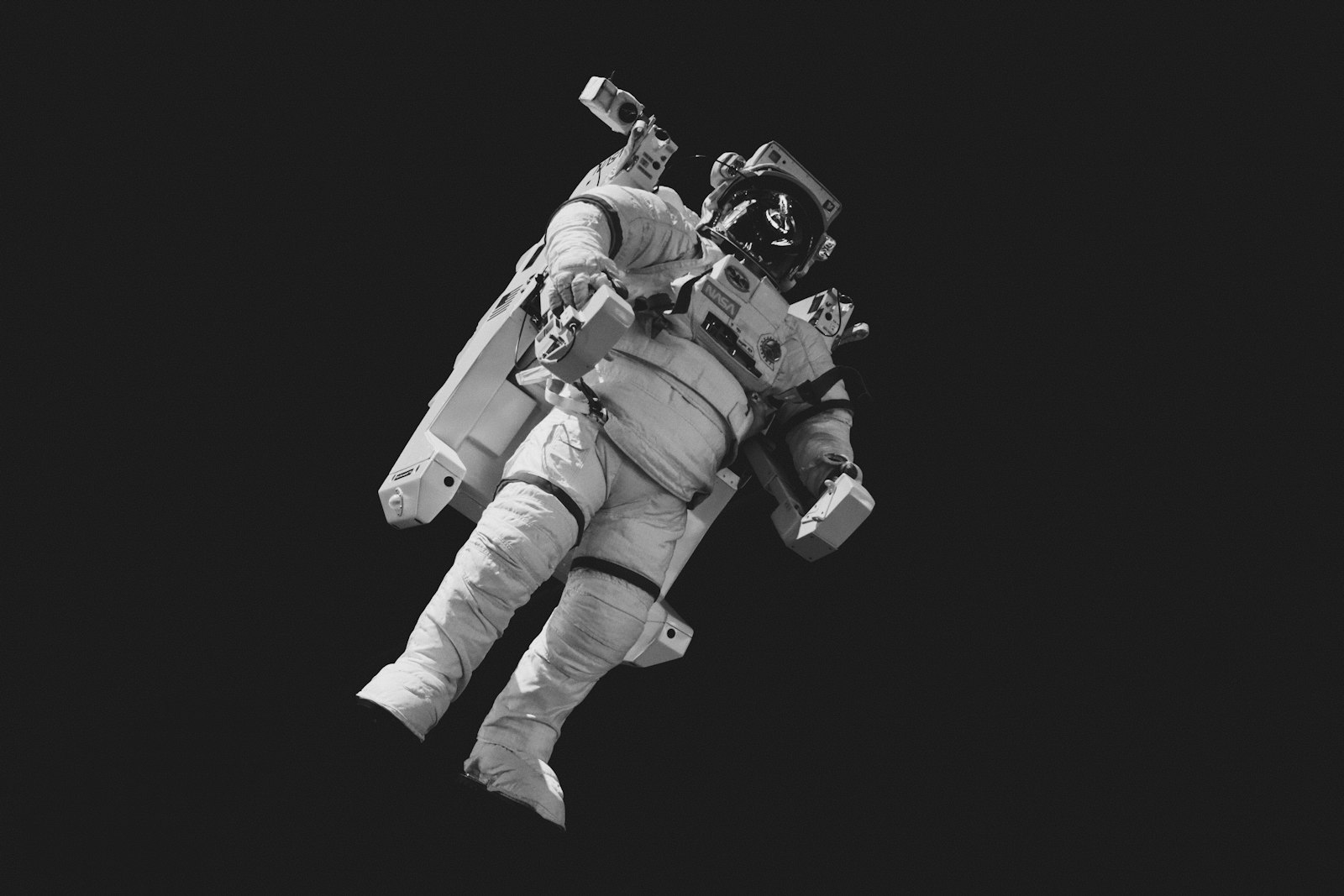 Astronaut on an extra-vehicular activity, floating against the black of space.
